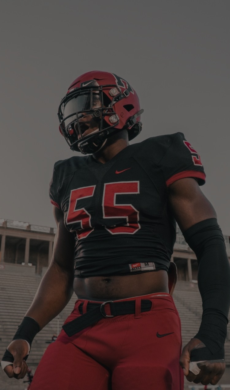 Football player walking, in red helmet