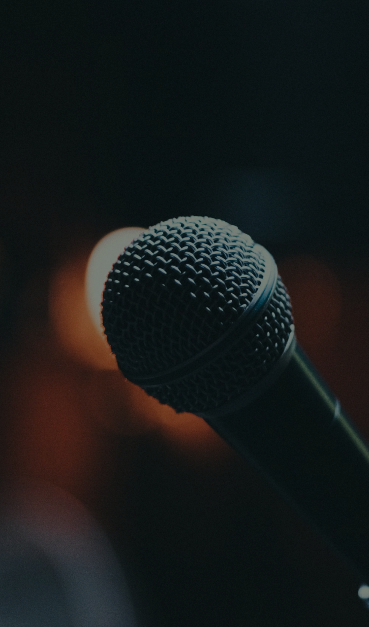 A microphone backlit by a spotlight.